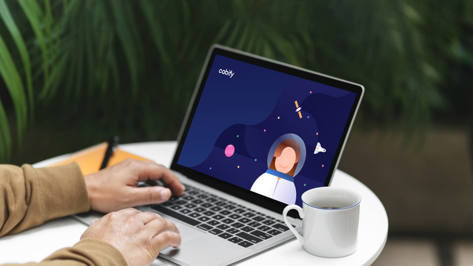 Un ordenador con una ilustración de Cabify como fondo de pantalla